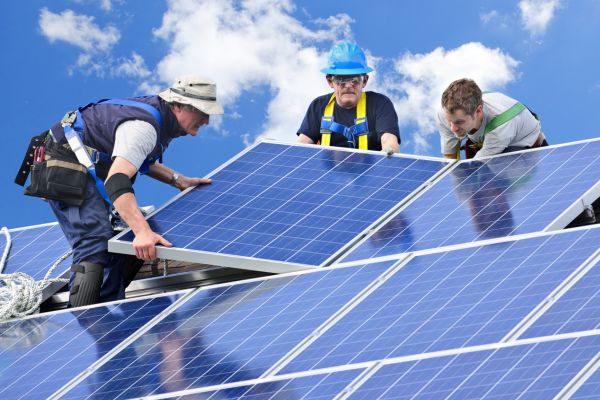 Technicians installing solar panels